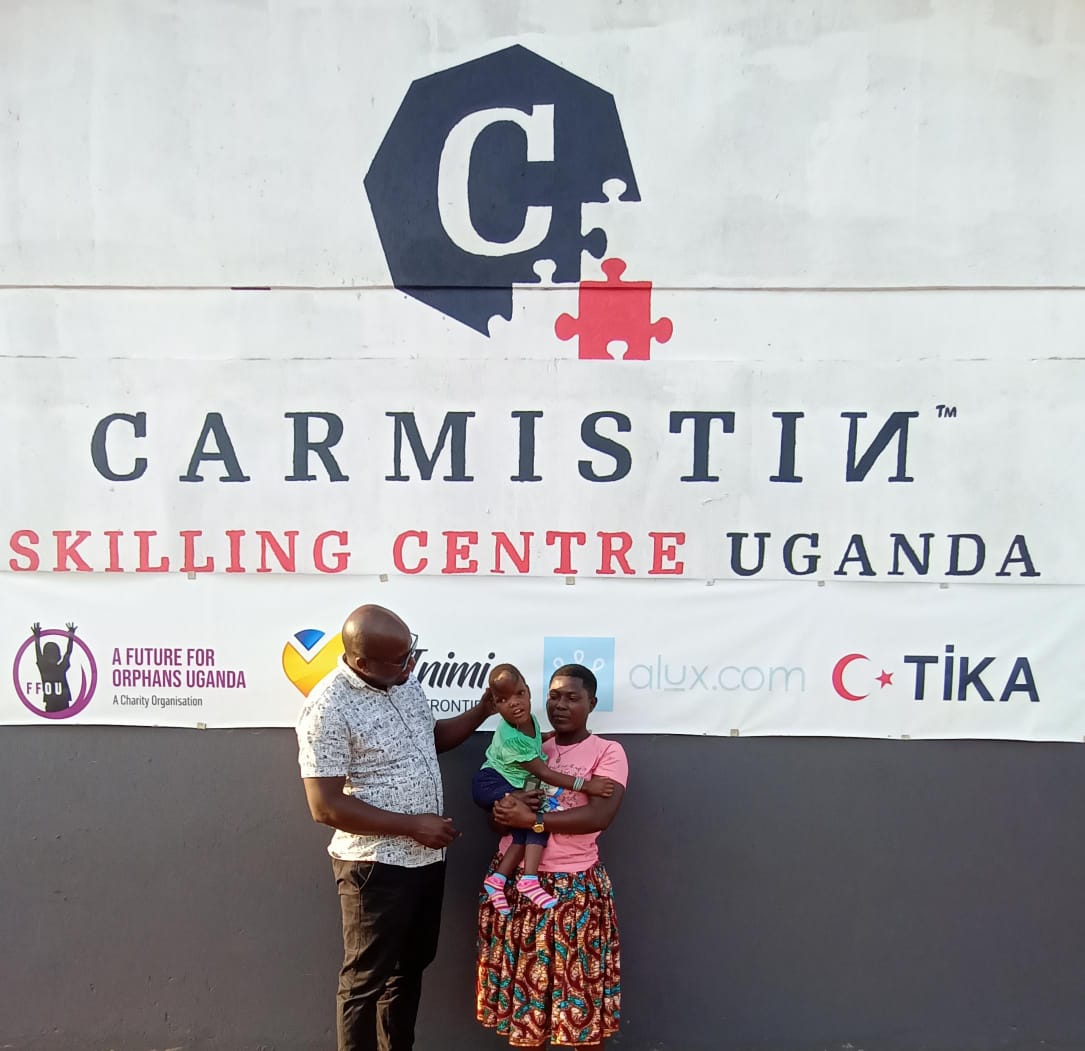 Carmistin Skilling Centre sign with family